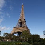 Captivating photo of the Eiffel Tower in Paris, showcasing its grandeur against a clear blue sky.