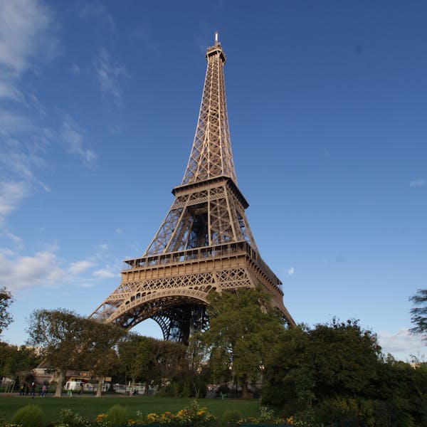 Captivating photo of the Eiffel Tower in Paris, showcasing its grandeur against a clear blue sky.