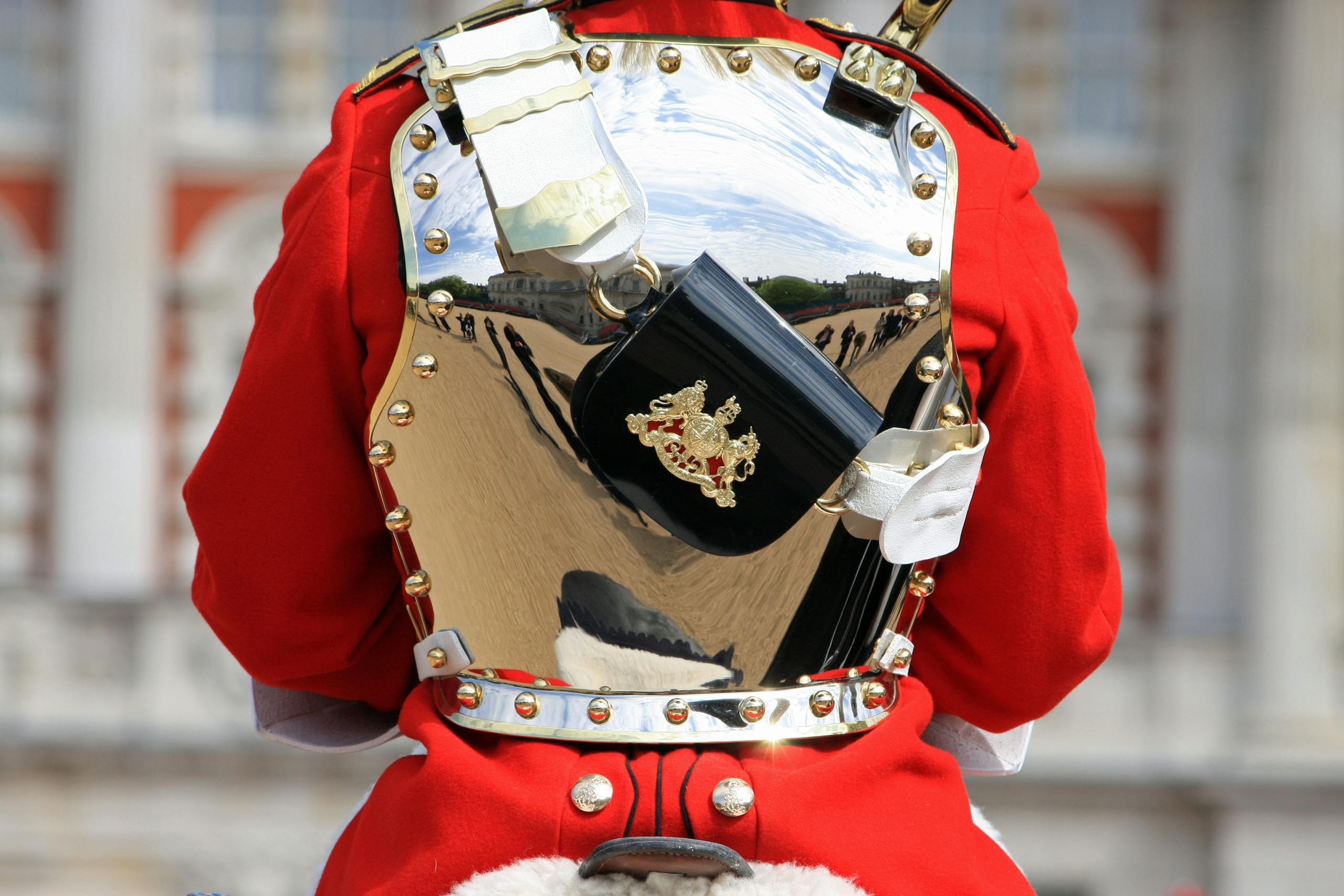 Close-up of a Household Cavalry soldier's polished breastplate reflecting surroundings.