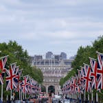 Union Jack flags line The Mall in London leading up to Admiralty Arch, showcasing British pride.